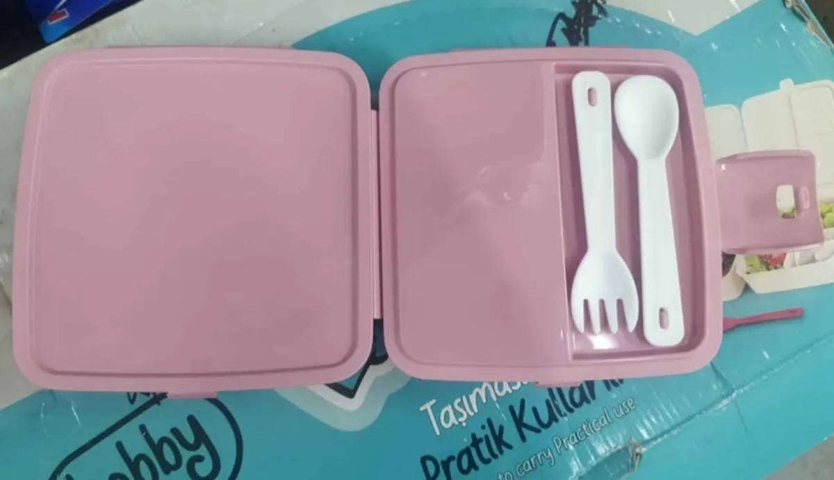Pink Bento style layered lunchbox with utensils