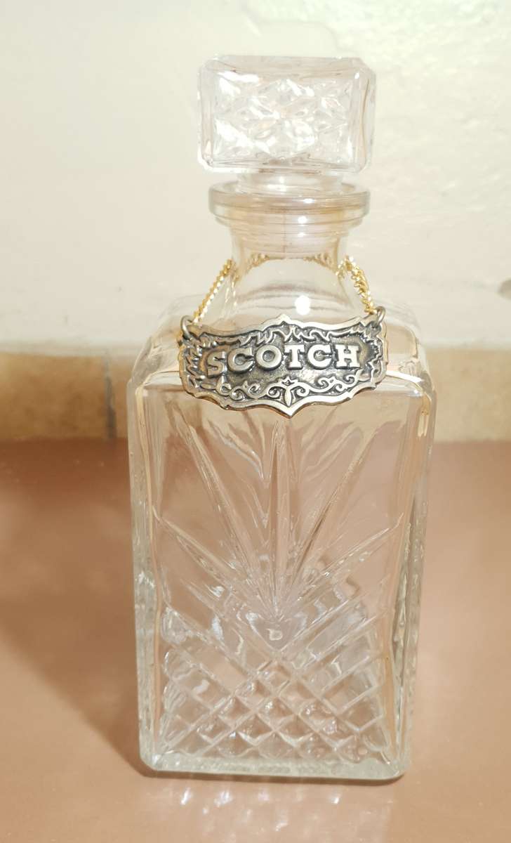 Demo stock - Cut glass modern whiskey decanter with brass whiskey tag in chain.