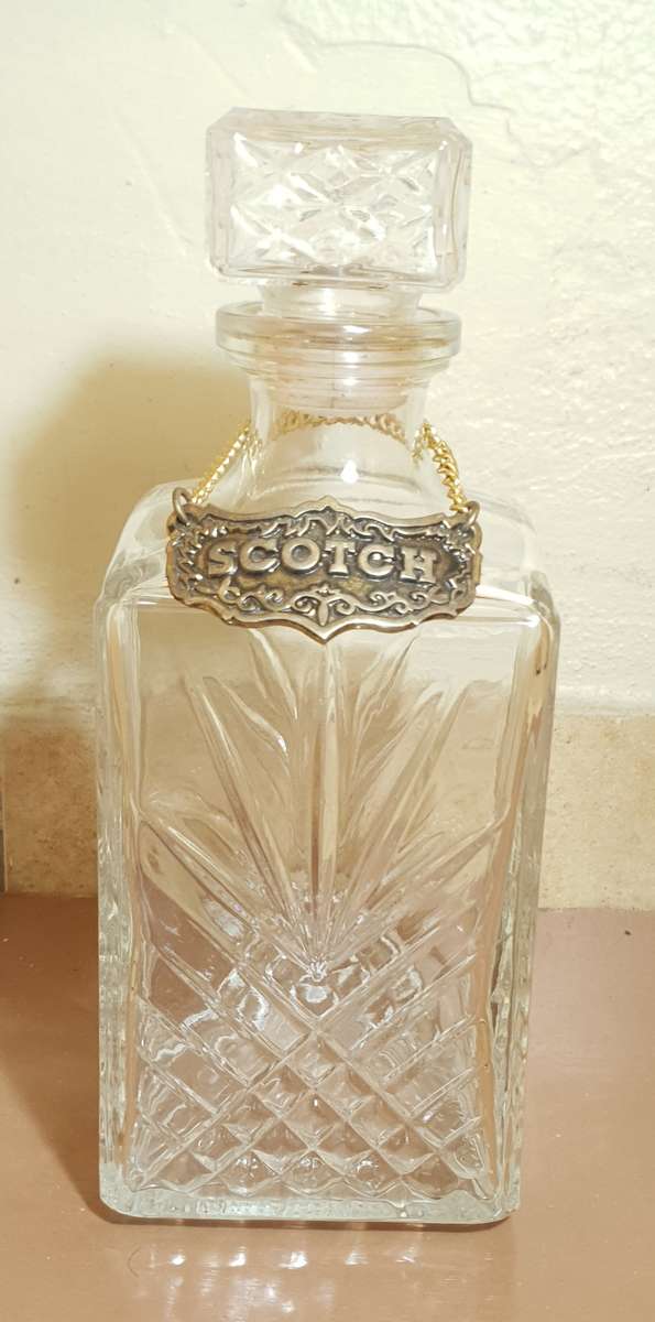 Demo stock - Cut glass modern whiskey decanter with brass whiskey tag in chain.