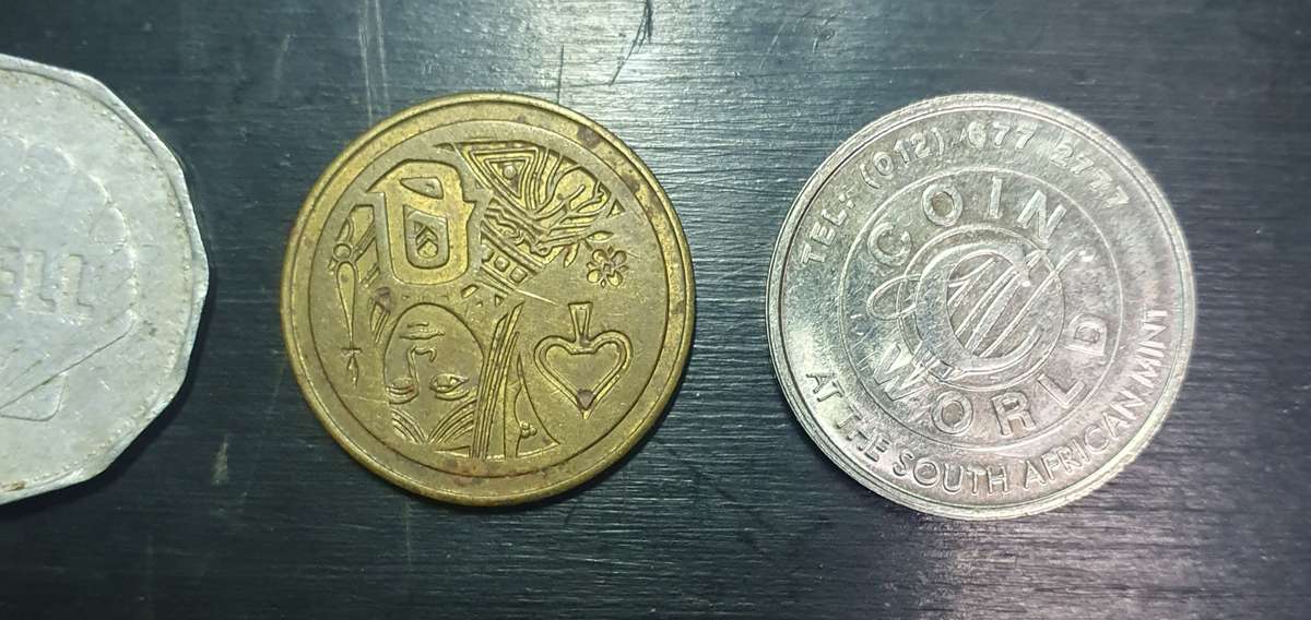 Collection of 4 tokens including a Van Reebeck & a SAPS coin by Coin World