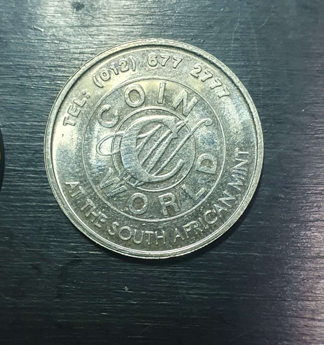 Collection of 4 tokens including a Van Reebeck & a SAPS coin by Coin World