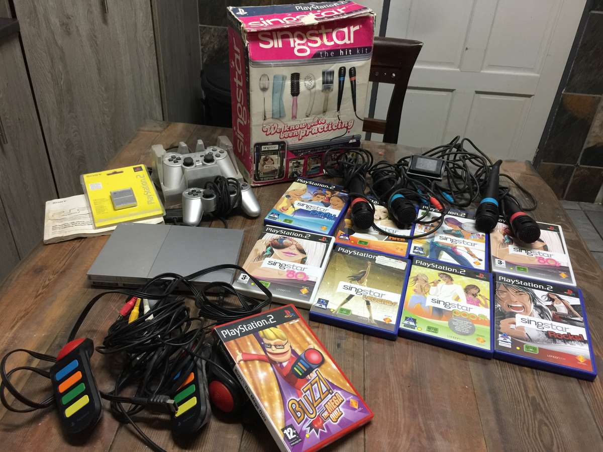 Play Station 2 complete +  Buzz + Singstar Games + 8MB Memory Card