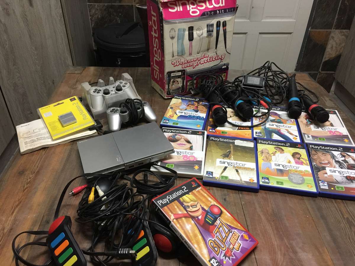 Play Station 2 complete +  Buzz + Singstar Games + 8MB Memory Card