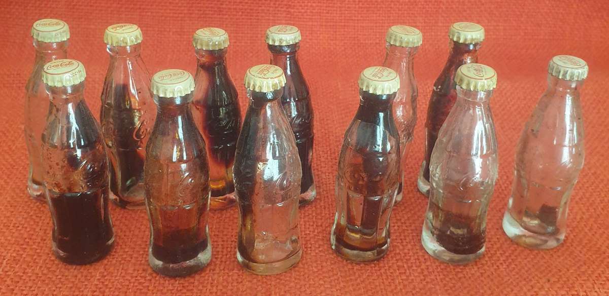 12 x Vintage miniature Coca-Cola bottles (with original caps)