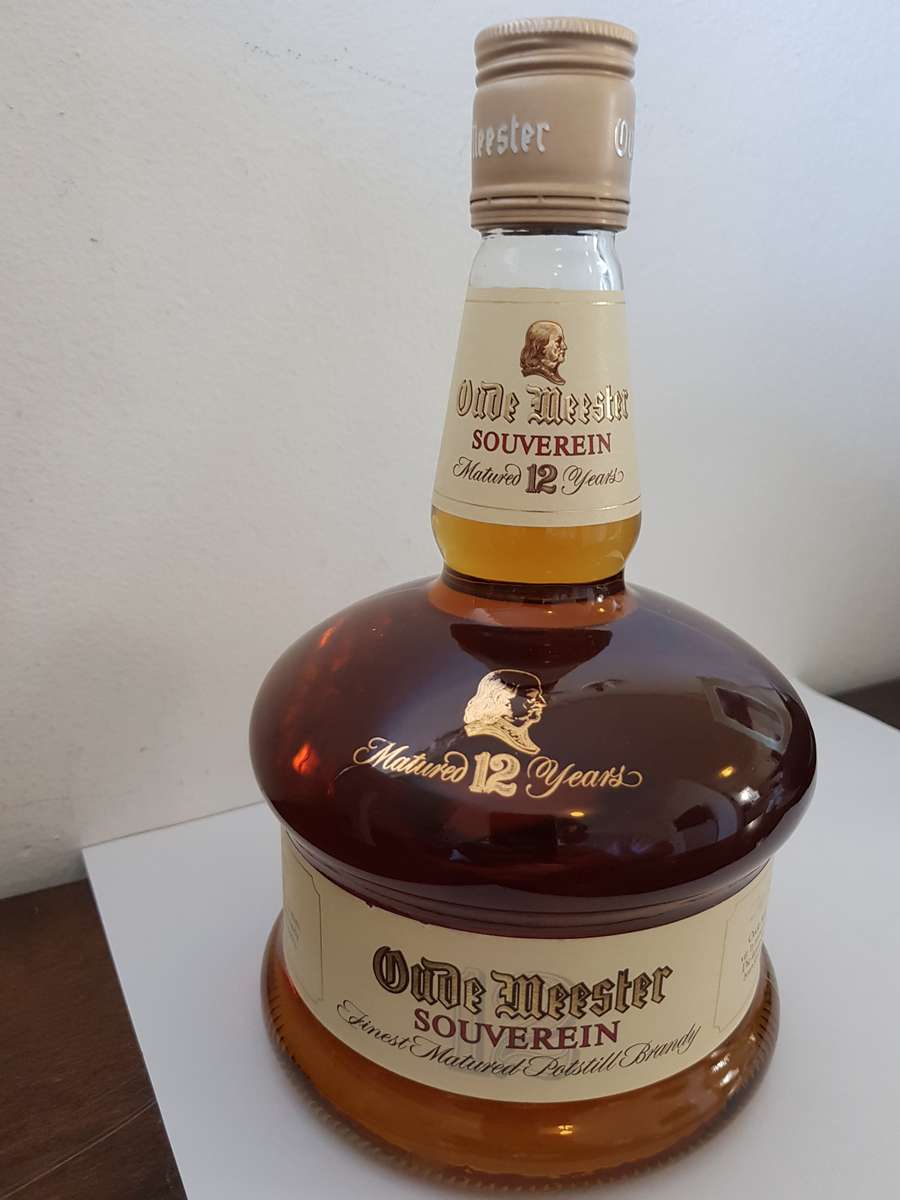 VINTAGE OUDEMEESTER SOUVEREIN POTSTILLED 12 YEAR OLD BRANDY IN UNIQUE SHAPED DECANTER.