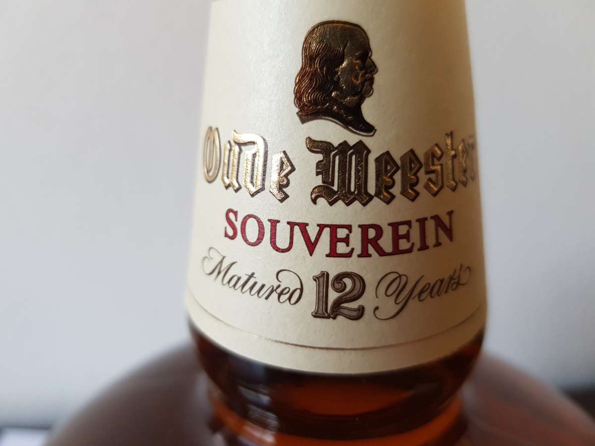 VINTAGE OUDEMEESTER SOUVEREIN POTSTILLED 12 YEAR OLD BRANDY IN UNIQUE SHAPED DECANTER.