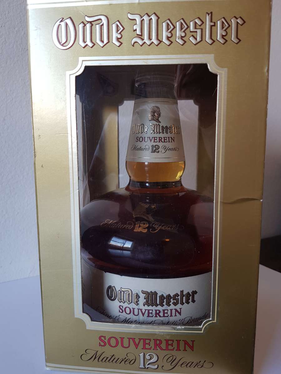 VINTAGE OUDEMEESTER SOUVEREIN POTSTILLED 12 YEAR OLD BRANDY IN UNIQUE SHAPED DECANTER.