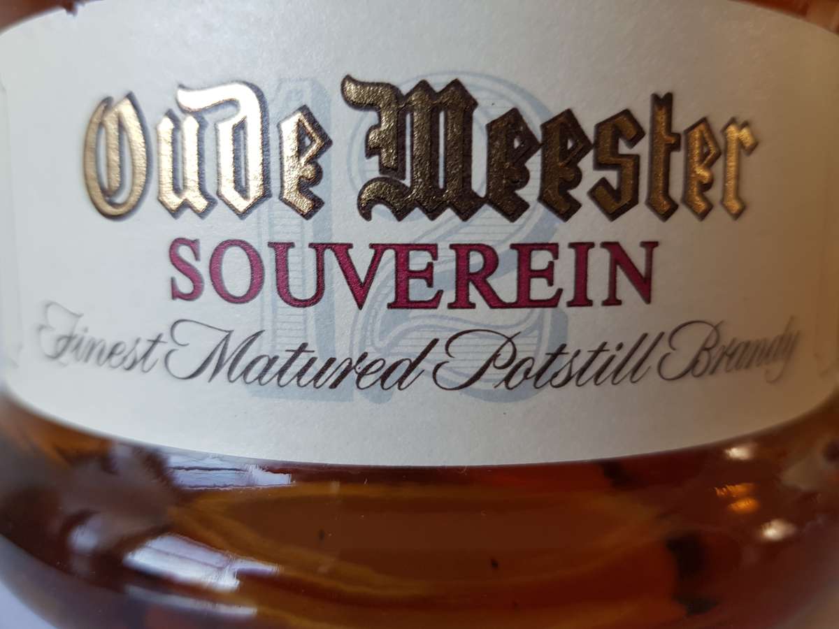 VINTAGE OUDEMEESTER SOUVEREIN POTSTILLED 12 YEAR OLD BRANDY IN UNIQUE SHAPED DECANTER.