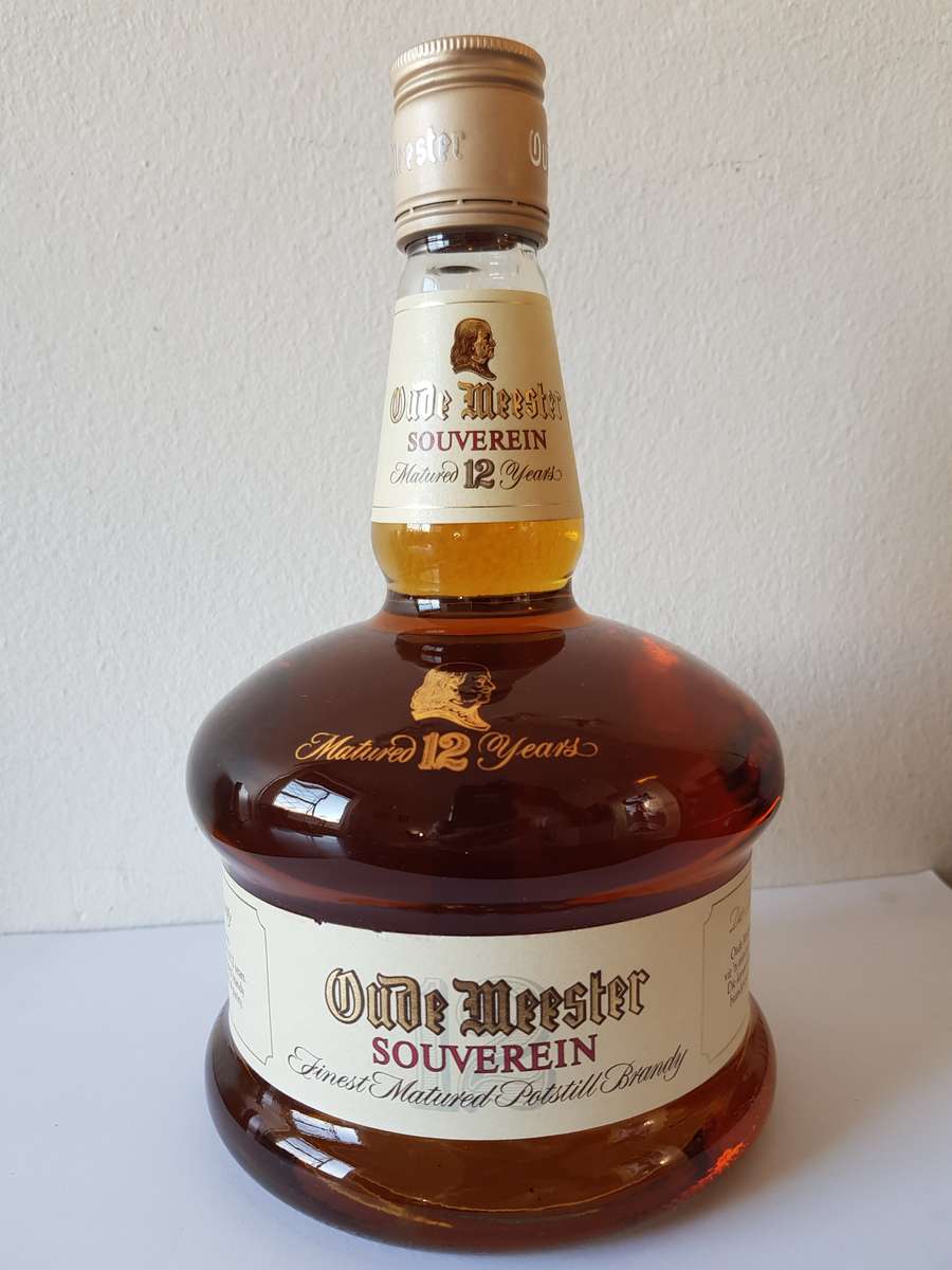 VINTAGE OUDEMEESTER SOUVEREIN POTSTILLED 12 YEAR OLD BRANDY IN UNIQUE SHAPED DECANTER.