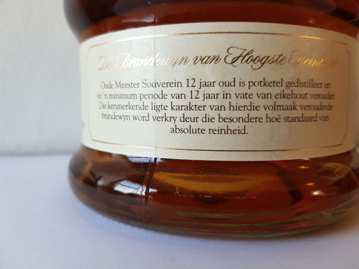 VINTAGE OUDEMEESTER SOUVEREIN POTSTILLED 12 YEAR OLD BRANDY IN UNIQUE SHAPED DECANTER.