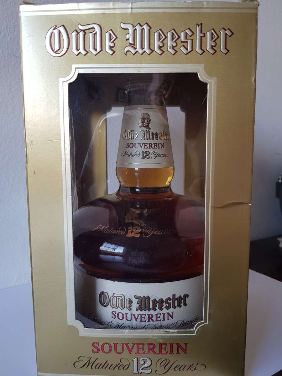 VINTAGE OUDEMEESTER SOUVEREIN POTSTILLED 12 YEAR OLD BRANDY IN UNIQUE SHAPED DECANTER.