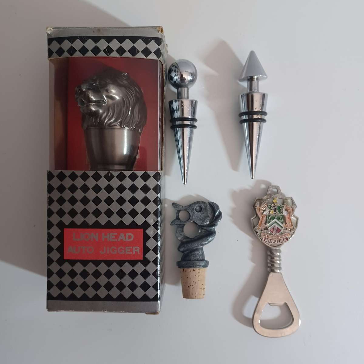 Vintage collection of bar accessories including: Lion Head Auto Jigger, Wine Stoppers