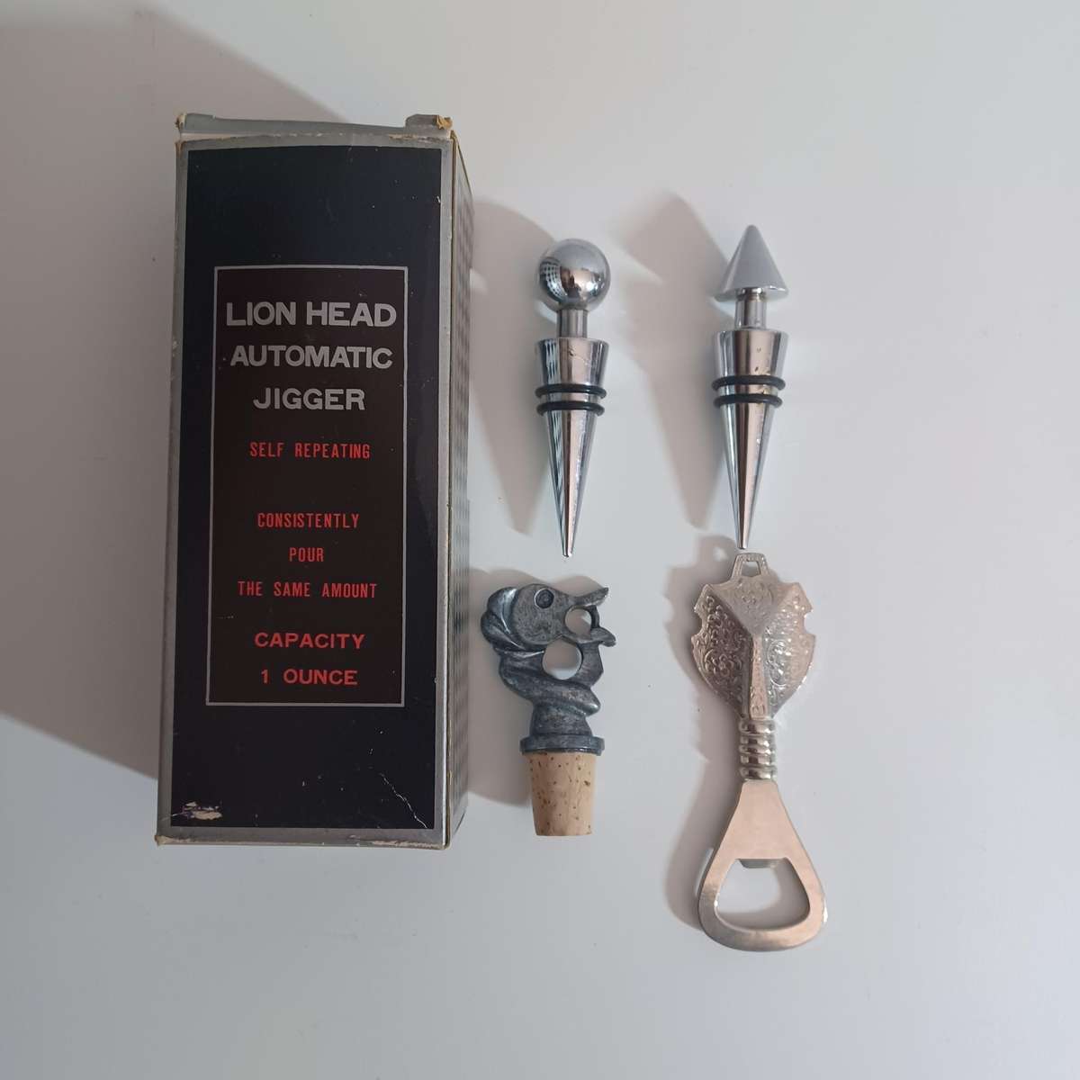 Vintage collection of bar accessories including: Lion Head Auto Jigger, Wine Stoppers