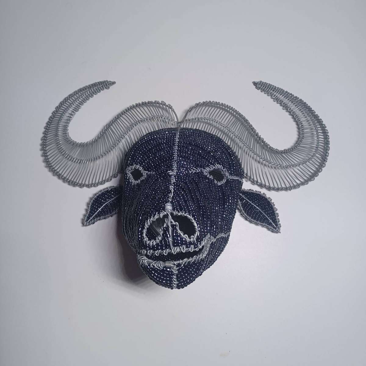 beaded and wire-frame African buffalo head wallpiece (38cm x 23cm x 20cm)