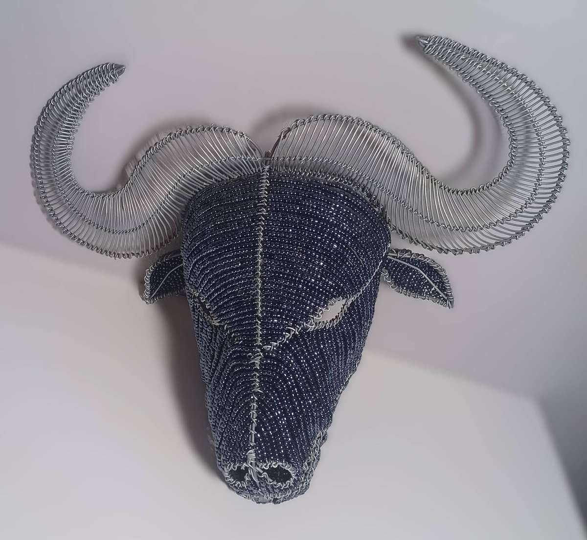 beaded and wire-frame African buffalo head wallpiece (38cm x 23cm x 20cm)