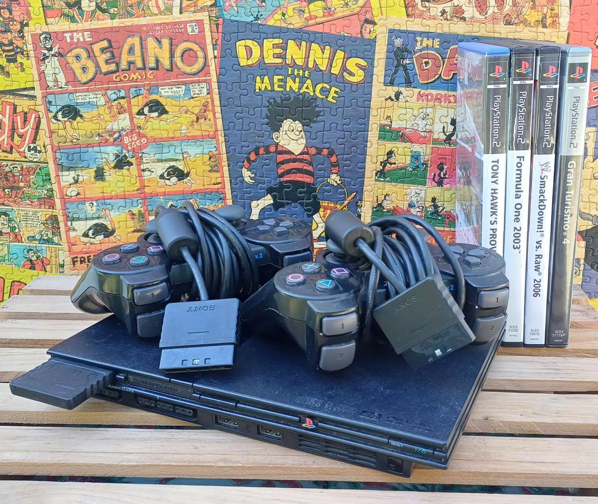 Playstation 2 - Black Slim c/w 2 x Controllers, AV Cable & Power Cord + 4 Games