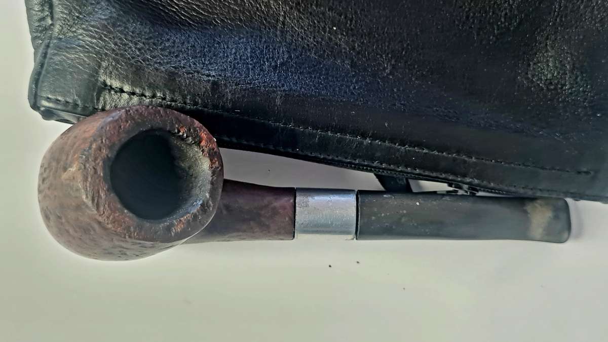 Smoking pipe, pipe cleaning tool and tobacco pouch.