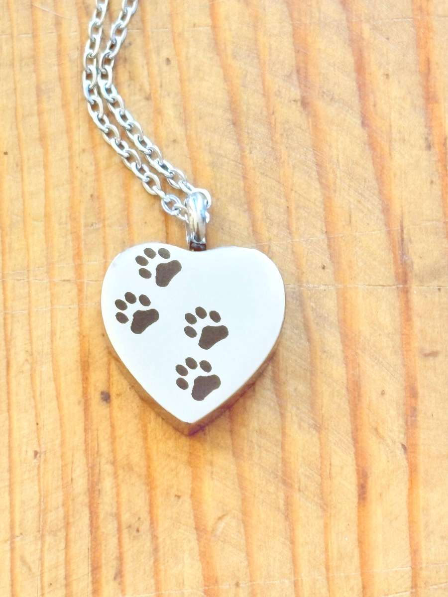 Keepsake urn pendant. Heart shaped, 4 paw prints. Stainless steel.