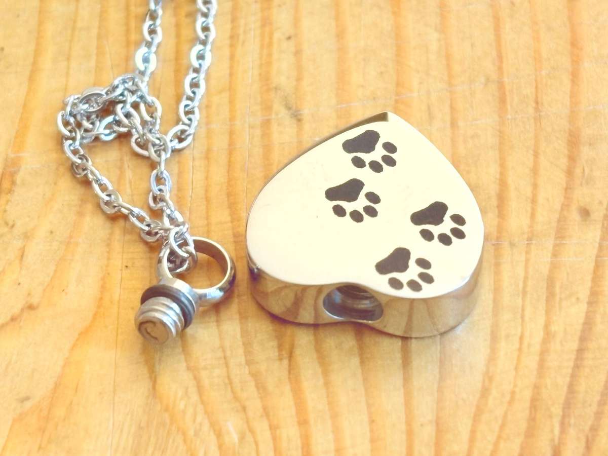 Keepsake urn pendant. Heart shaped, 4 paw prints. Stainless steel.