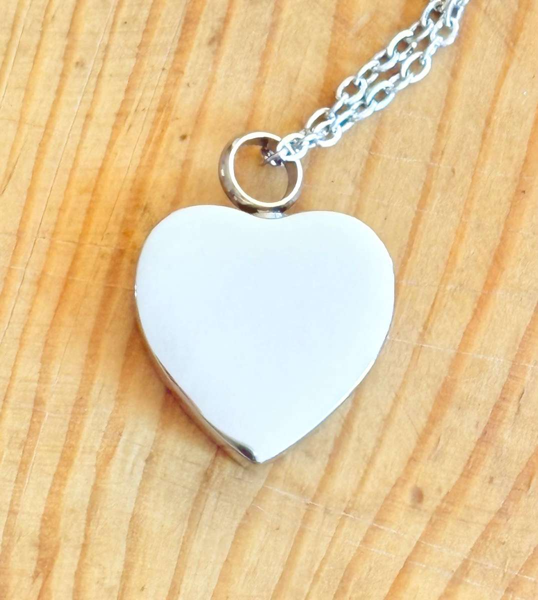 Keepsake urn pendant. Heart shaped, 4 paw prints. Stainless steel.