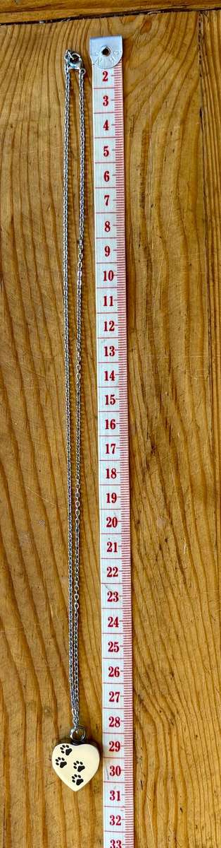 Keepsake urn pendant. Heart shaped, 4 paw prints. Stainless steel.