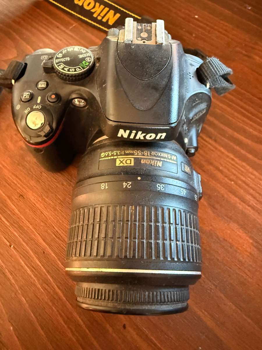 Nikon D5100 DSLR camera with 2 lenses, flash and spare batteries and charger