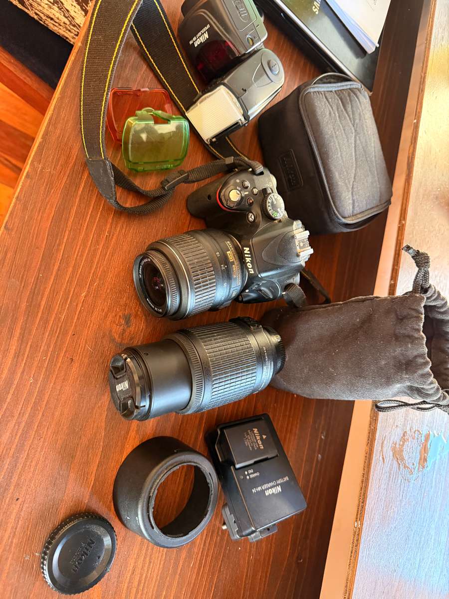Nikon D5100 DSLR camera with 2 lenses, flash and spare batteries and charger