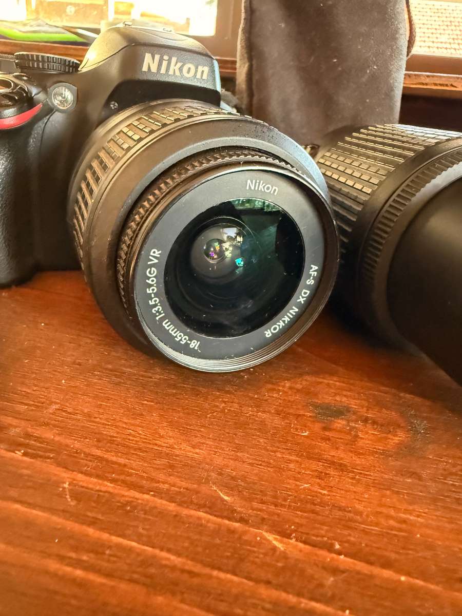 Nikon D5100 DSLR camera with 2 lenses, flash and spare batteries and charger