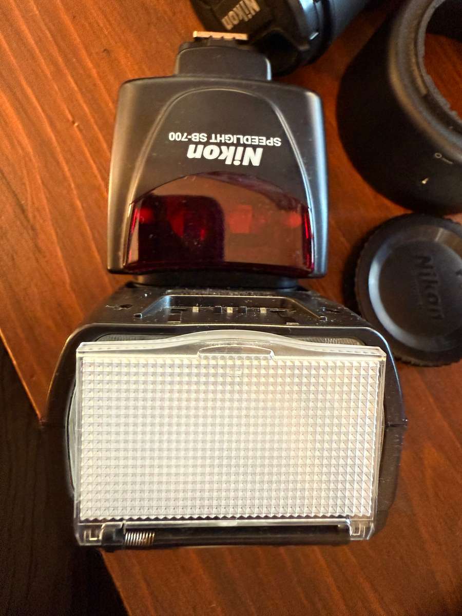 Nikon D5100 DSLR camera with 2 lenses, flash and spare batteries and charger