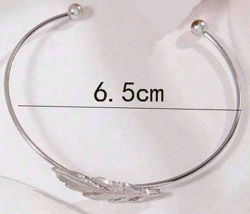 Silver cuff bracelet with feather