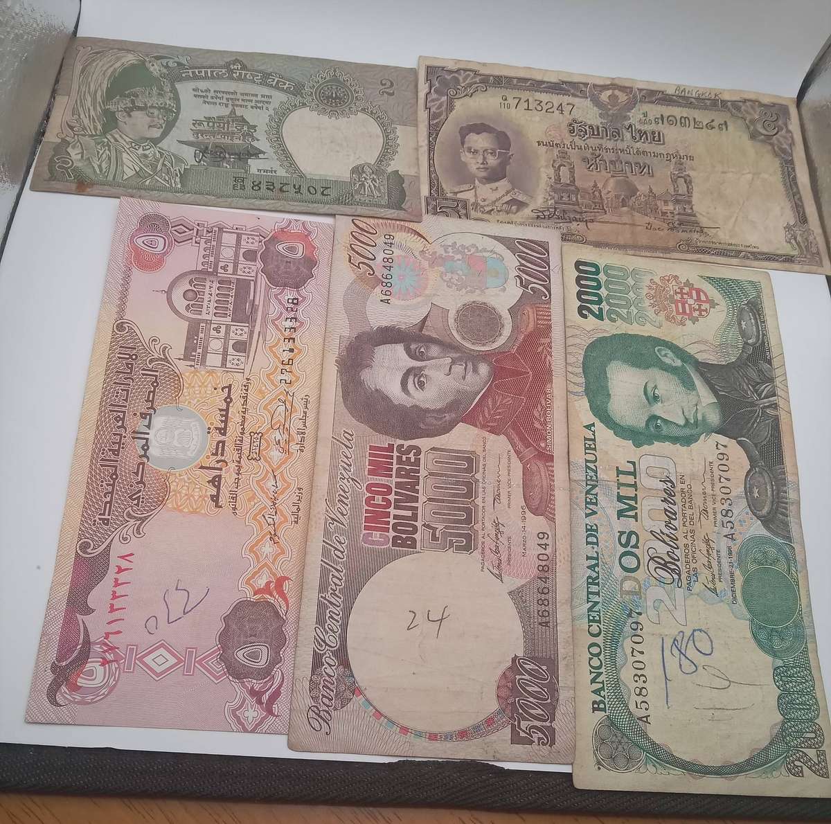 FIVE INTERNATIONAL BANK NOTES - SOME WRITING SHOWING ON NOTES