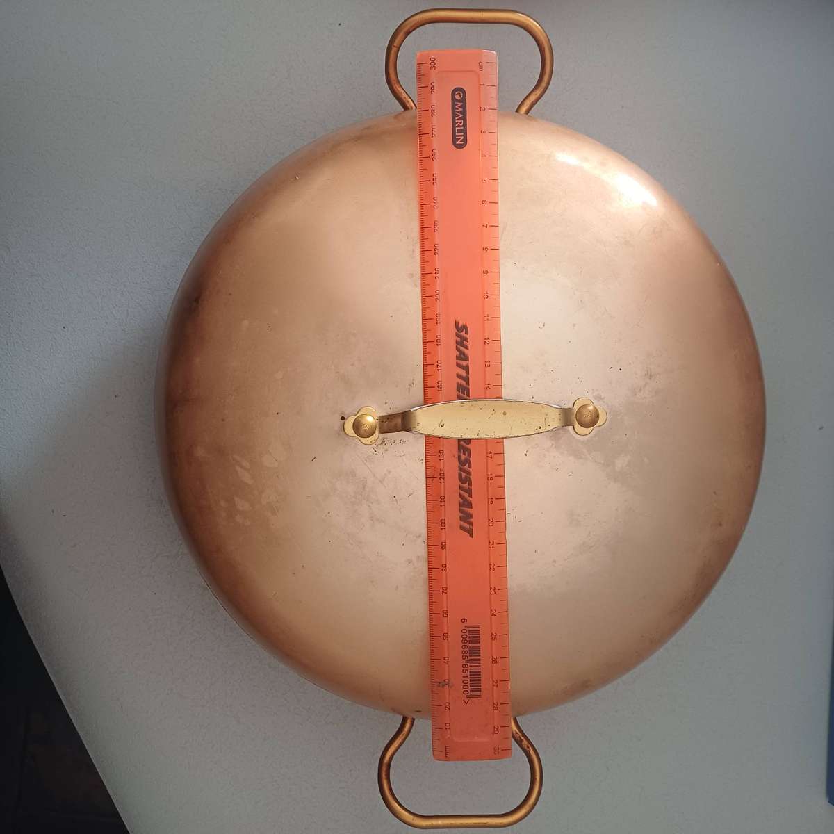 vintage copper cataplana pan featuring distinctive brass handles and lid.