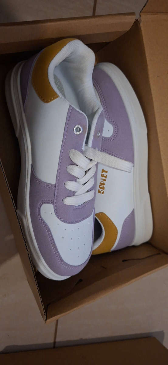 These are Soviet Society 23 sneakers in white and lilac, featuring a distinctive gold heel