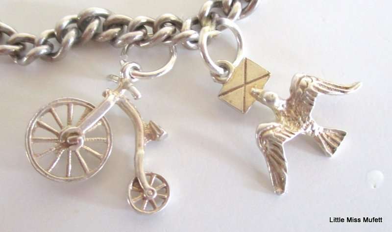 A Sterling silver charm bracelet with some interesting charms and a St. Christopher--21 Gram plus