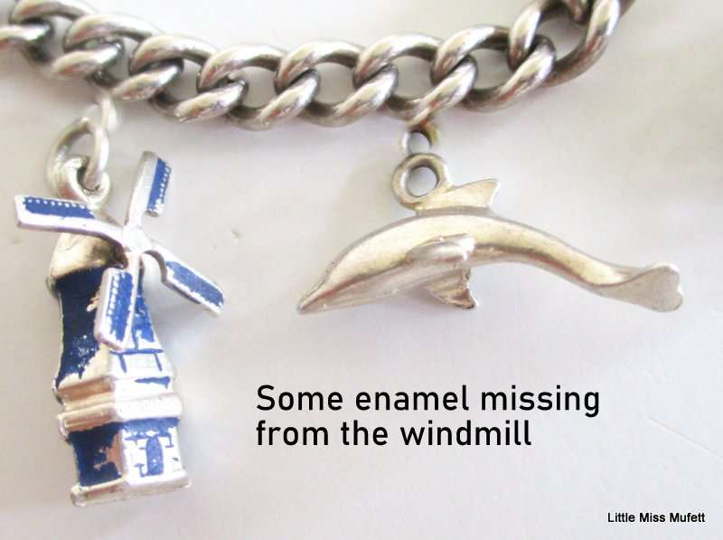 A Sterling silver charm bracelet with some interesting charms and a St. Christopher--21 Gram plus