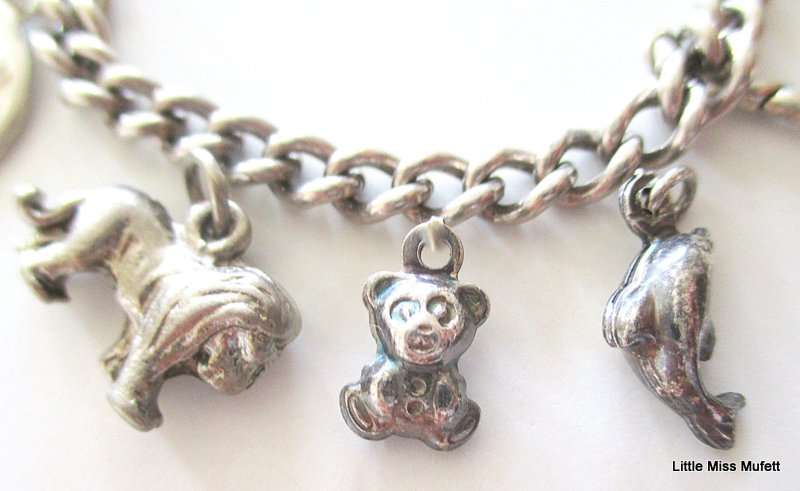A Sterling silver charm bracelet with some interesting charms and a St. Christopher--21 Gram plus