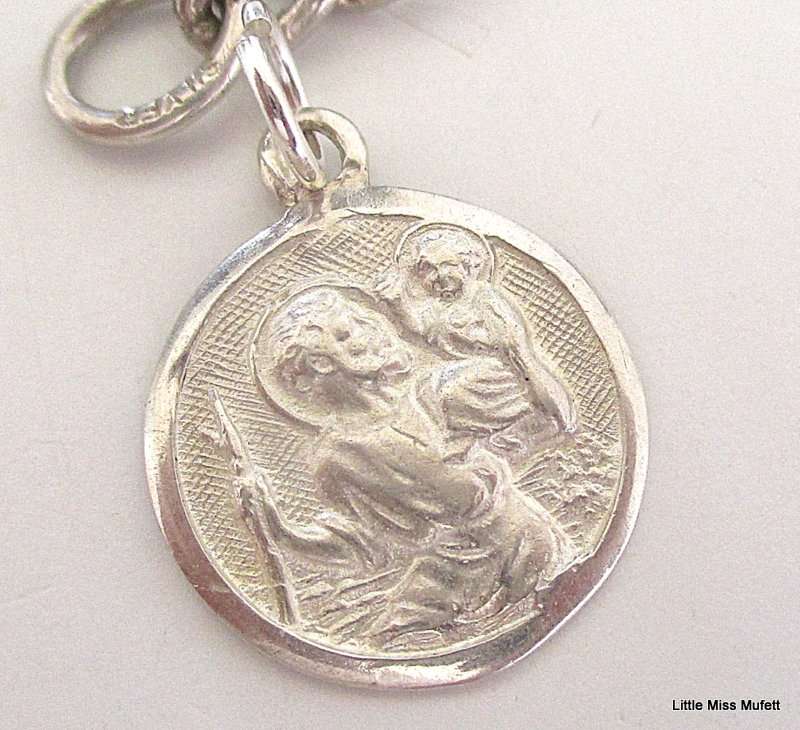 A Sterling silver charm bracelet with some interesting charms and a St. Christopher--21 Gram plus