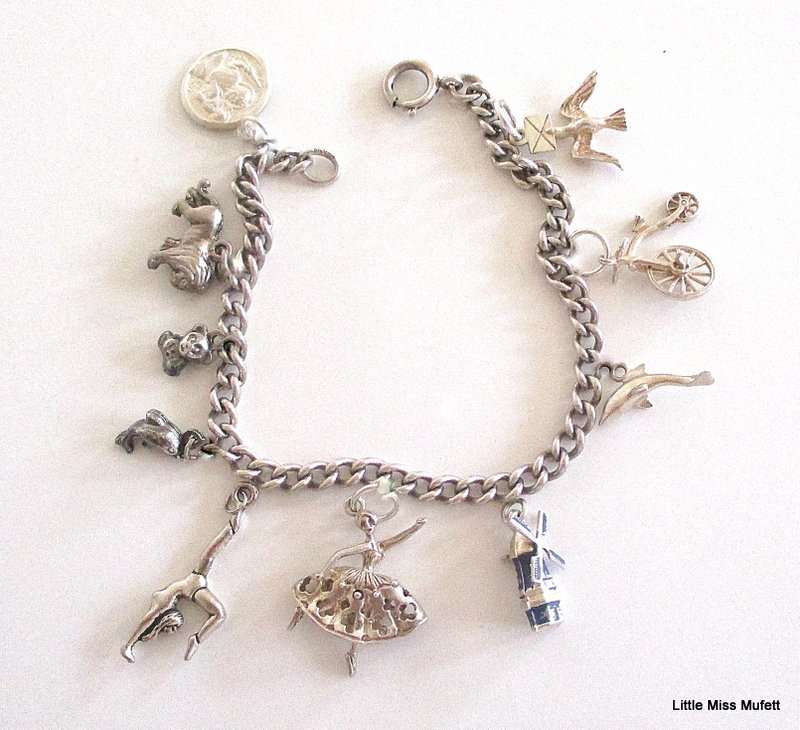 A Sterling silver charm bracelet with some interesting charms and a St. Christopher--21 Gram plus