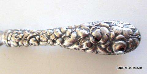 A fairly large sterling silver letter opener in a leather cover-- Sterling silver handle