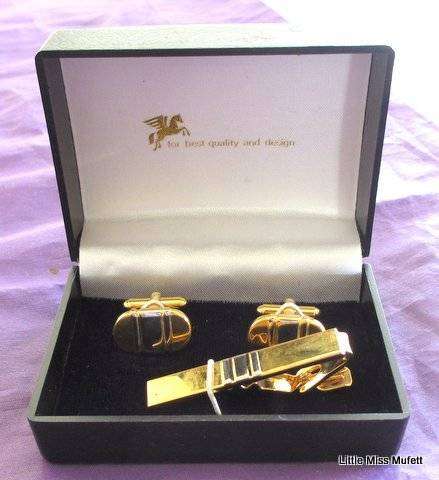 Cufflinks in a carved wooden box and two boxed cufflink sets