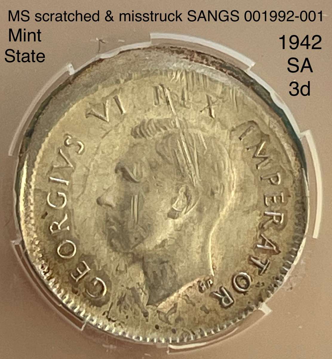 Rare misstruck (extra rare broadstruck?) graded 1942 SA tickey 3d.