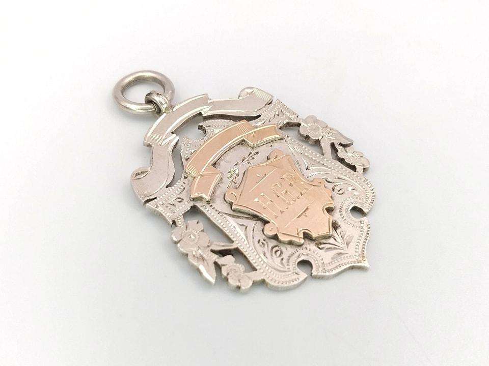 Sterling silver and yellow gold fob medal