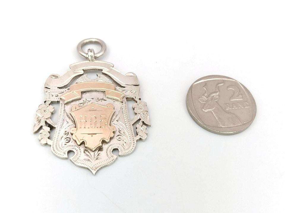 Sterling silver and yellow gold fob medal