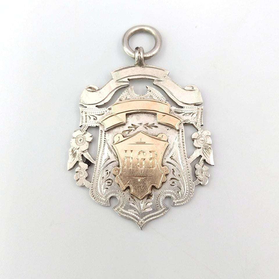Sterling silver and yellow gold fob medal