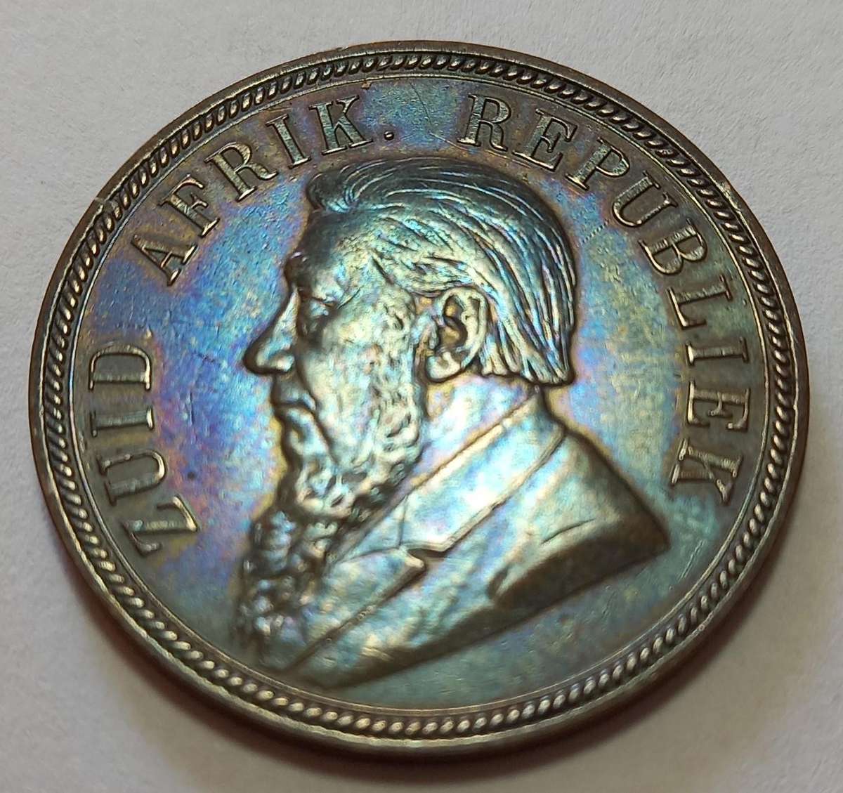 ZAR 1894,  1 Penny,  AUC ? Rainbow coloring, excellent coin.