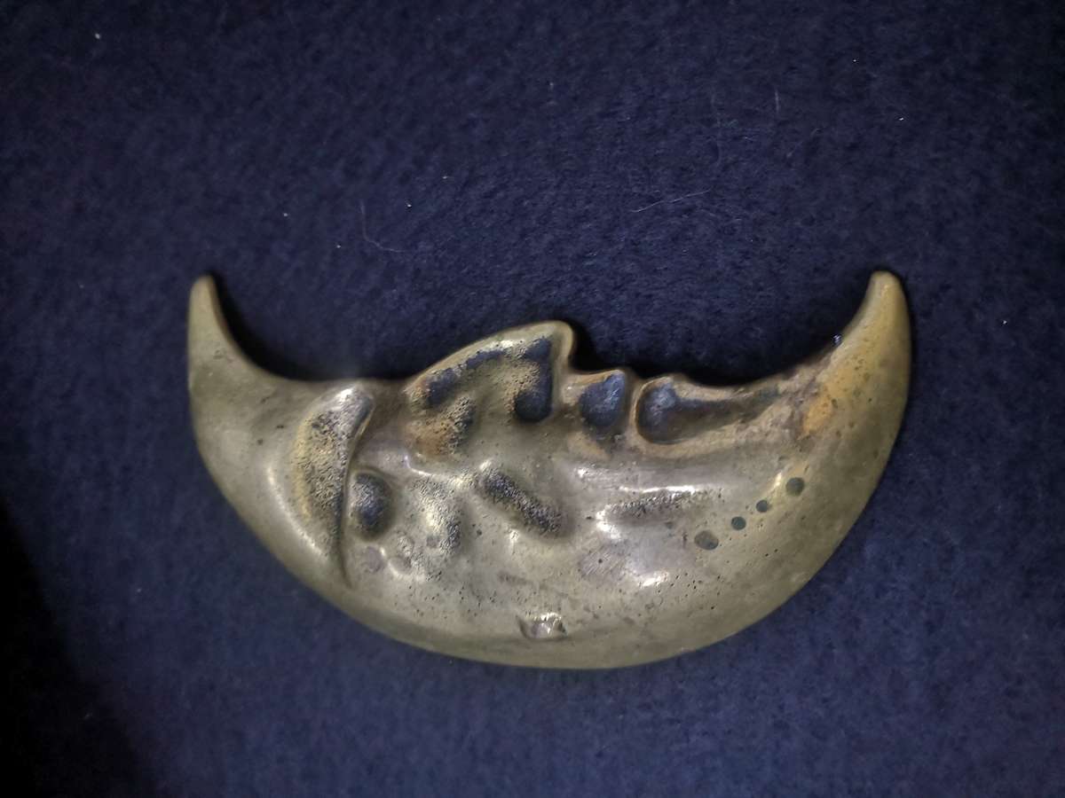 Brass crescent moon face