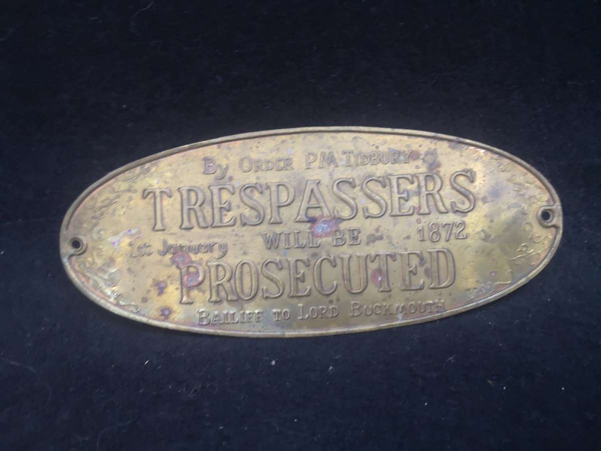 Brass sign: Trespassers will be prosecuted
