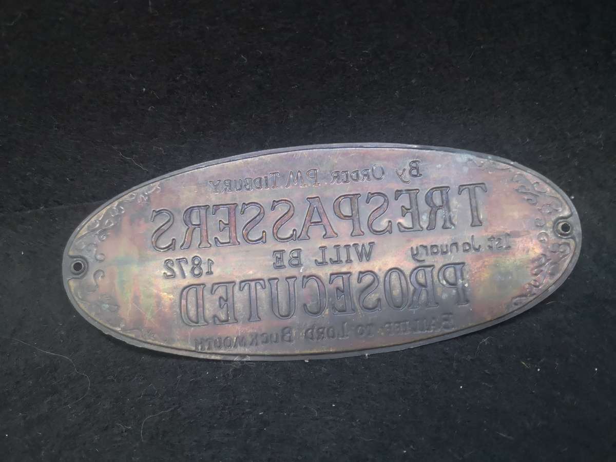 Brass sign: Trespassers will be prosecuted