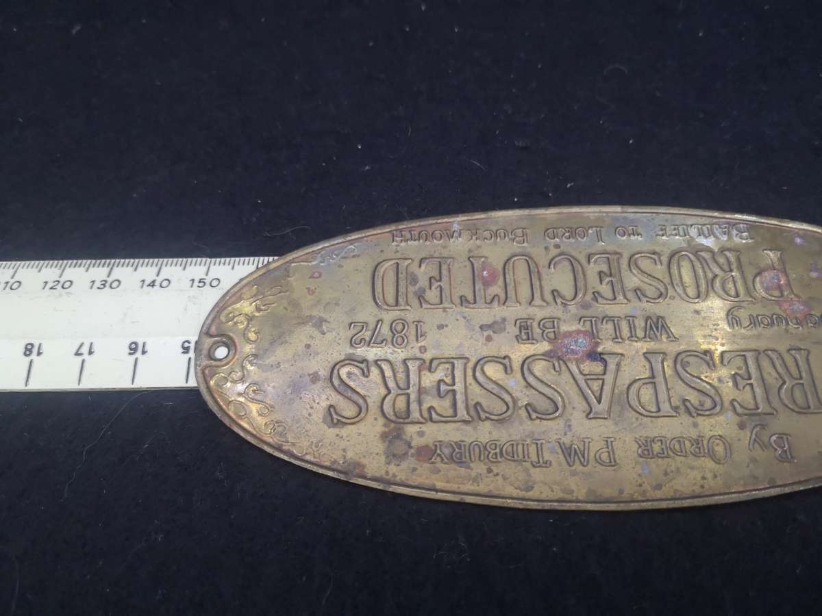 Brass sign: Trespassers will be prosecuted