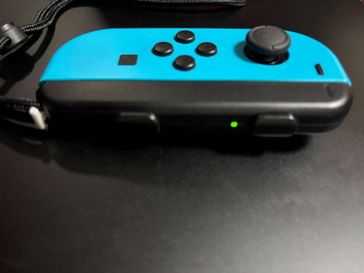 neon blue Left Joy-Con controller for Nintendo Switch with strap